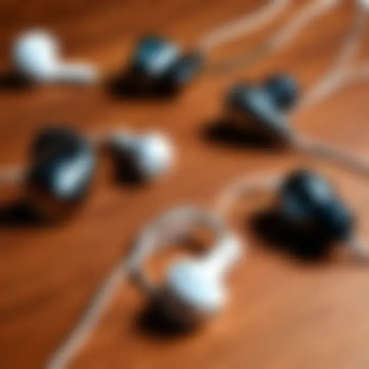 An array of wired earbuds placed on a wooden surface, highlighting variety